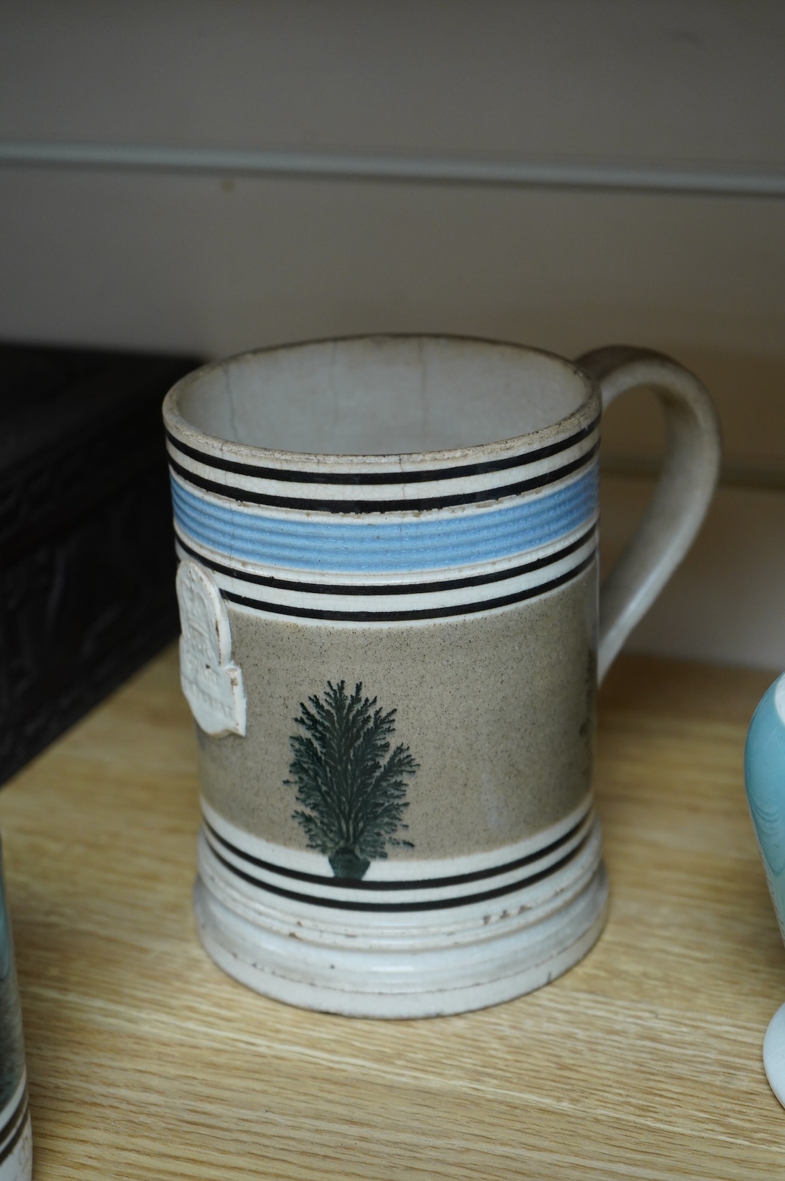 Two early 19th century Mocha ware jugs and two mugs, largest 16cm high